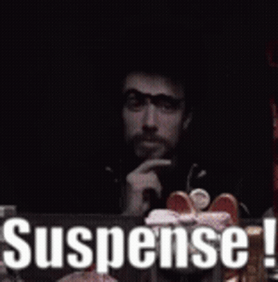 Man Sitting At Table With Suspense Sign GIF