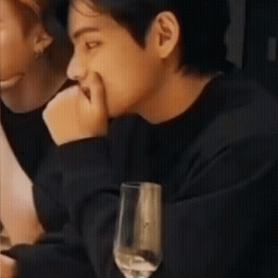 Man Sitting At Table With Wine And Cell Phone GIF