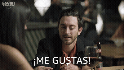 Man Sitting At Table With Wine And Laugh Track Logo GIF