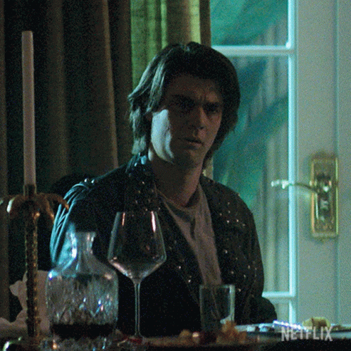 Man Sitting At Table With Wine And Netflix GIF
