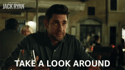 Man Sitting At Table With Wine Saying Take A Look Around GIF