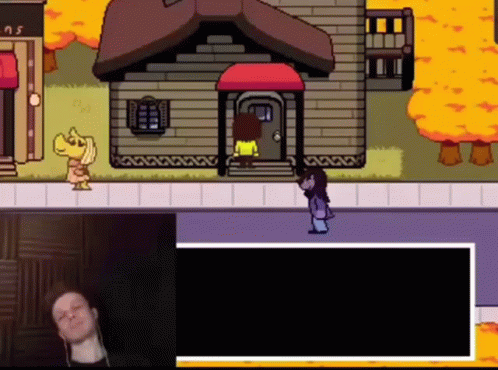 Man Sitting At Video Game Screen With Woman Standing In Front Of House GIF