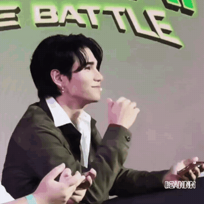Man Sitting By Banner Saying Battle GIF