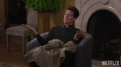 Man Sitting By Fireplace With Netflix Logo GIF
