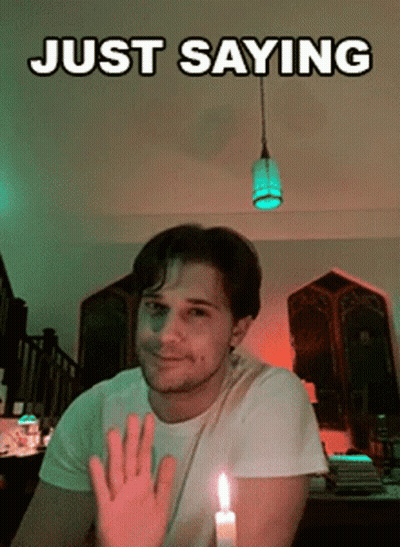 Man Sitting By Lit Candle Saying Just GIF