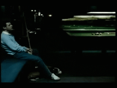 Man Sitting By Pool Table With Cue GIF
