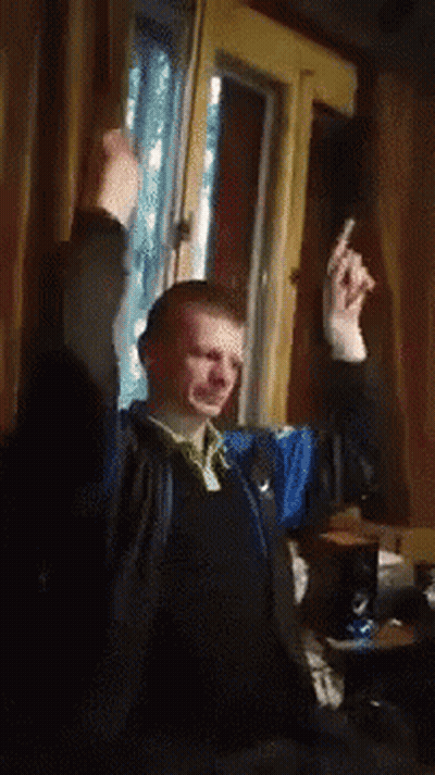Man Sitting By Window With Hands In Air GIF