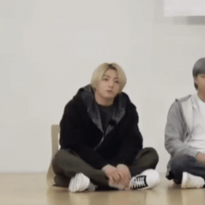 Man Sitting Cross-Legged Next To Woman GIF