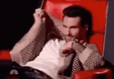Man Sitting Crossed Legs In Red Chair GIF