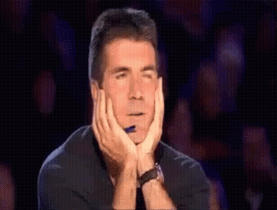 Man Sitting Hands On Chin In Crowd GIF