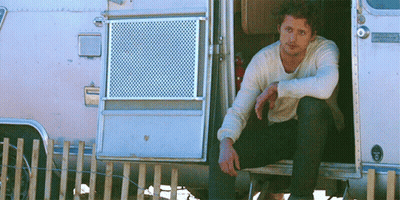 Man Sitting In Airstream Camper Doorway GIF