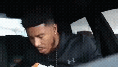 Man Sitting In Back Seat Eating Burger GIF