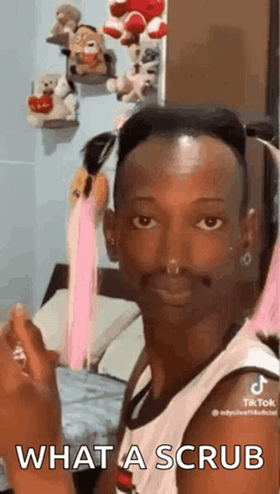 Man Sitting In Bedroom Holding Perfume Making Face GIF