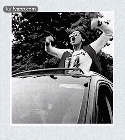 Man Sitting In Car Arms Outstretched Shouting GIF