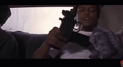 Man Sitting In Car Holding Gun GIF