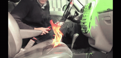 Man Sitting In Car Holding Scissors With Flame GIF