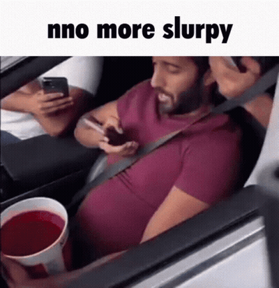 Man Sitting In Car On Phone Holding Red Drink GIF