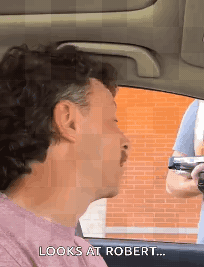 Man Sitting In Car Watching Gun GIF