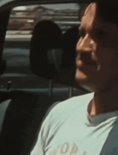 Man Sitting In Car Wearing White Shirt Saying Hop GIF