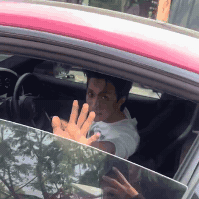 Man Sitting In Car With Hand Out GIF