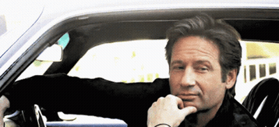 Man Sitting In Car With Hand To Chin GIF