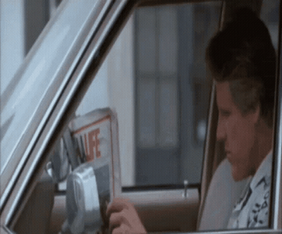 Man Sitting In Car With Newspaper GIF