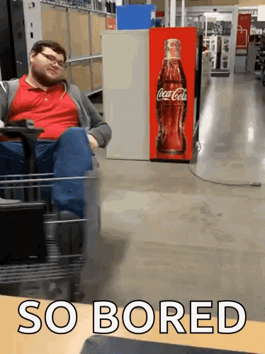 Man Sitting In Cart In Front Of Coca Cola Machine GIF