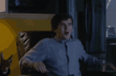 Man Sitting In Chair Arms Outstretched GIF
