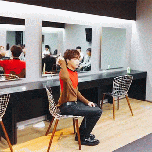 Man Sitting In Chair Before Mirror GIF