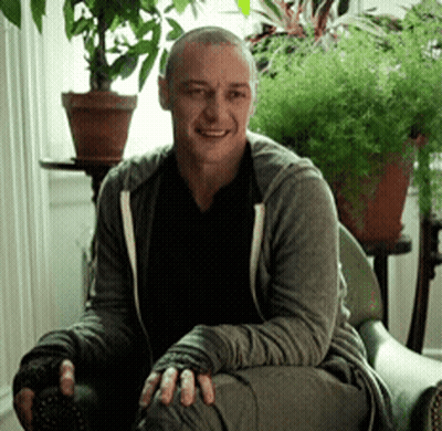 Man Sitting In Chair By Window With Potted Plants GIF