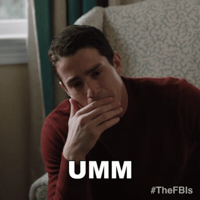 Man Sitting In Chair Covering Mouth Saying Umm GIF