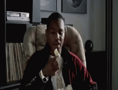 Man Sitting In Chair Eating Pizza GIF