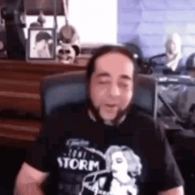 Man Sitting In Chair Eyes Closed Black T-Shirt GIF