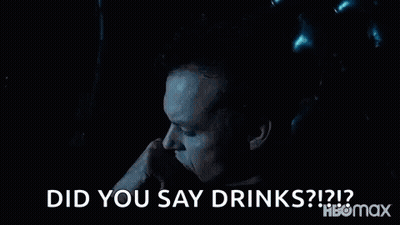Man Sitting In Chair Hand To Mouth Saying Did You Say Drinks GIF