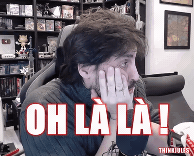 Man Sitting In Chair Hands On Face Saying Oh La La GIF