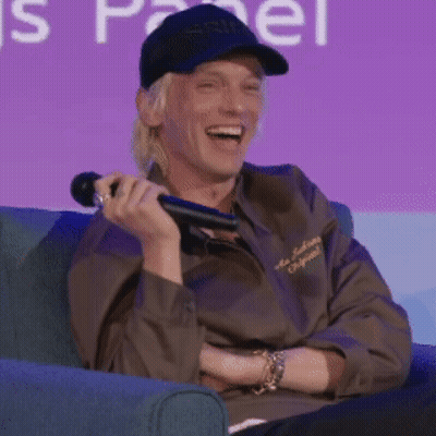 Man Sitting In Chair Holding Microphone Smiling GIF
