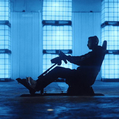 Man Sitting In Chair Holding Steering Wheel GIF