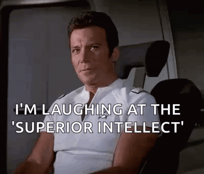 Man Sitting In Chair Laughing At Superior Intellect GIF