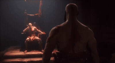Man Sitting In Chair Looking At Another Man In Dark Room GIF
