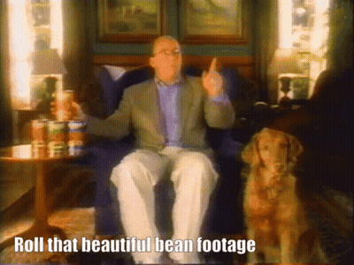 Man Sitting In Chair Next To Dog Saying Roll That Beautiful Bean Footage GIF