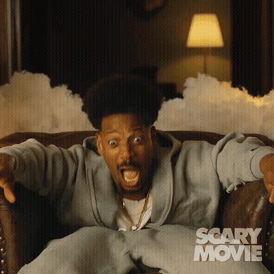 Man Sitting In Chair Saying Scary Movie GIF