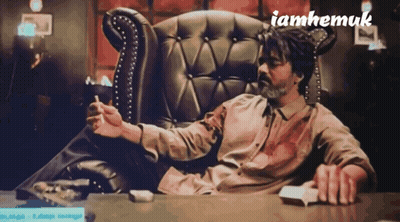 Man Sitting In Chair Smoking Cigarette GIF