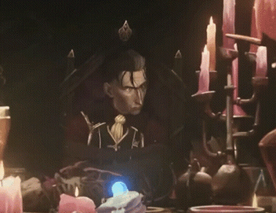 Man Sitting In Chair Surrounded By Candles And Statue GIF