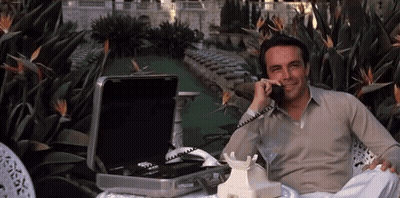 Man Sitting In Chair Talking On Phone GIF