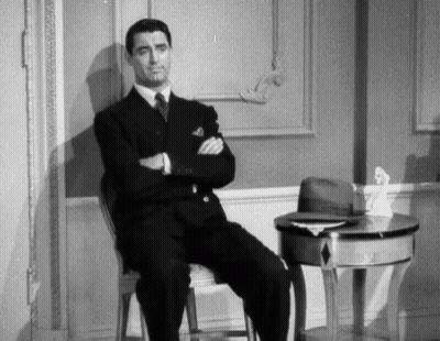 Man Sitting In Chair With Arms Crossed GIF