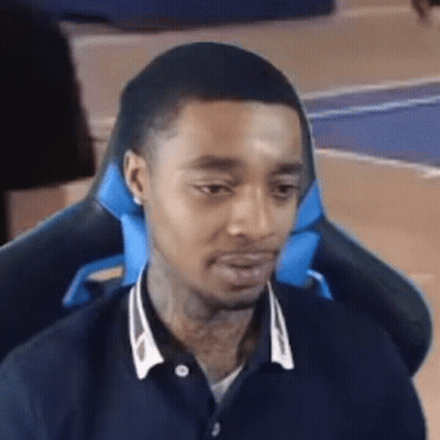 Man Sitting In Chair With Blue Pillow GIF