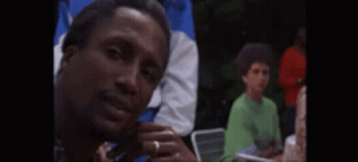 Man Sitting In Chair With Eyes Closed Surrounded By People GIF