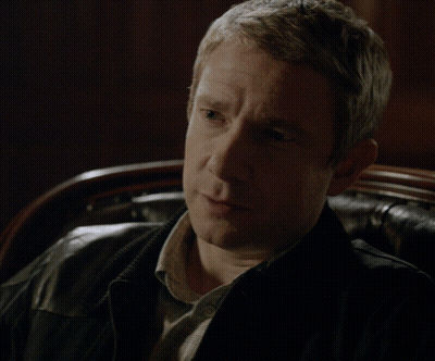 Man Sitting In Chair With Finger To Lips GIF
