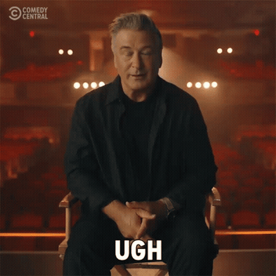 Man Sitting In Chair With Hand On Face Comedy Central Logo GIF