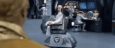 Man Sitting In Chair With Letter G GIF